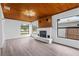 Living room with white fireplace and hardwood style flooring at 9033 3Rd N St, St Petersburg, FL 33702