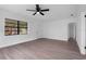 Bright living room with modern fan, fresh paint, beautiful flooring and natural light from the window at 9033 3Rd N St, St Petersburg, FL 33702