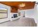 Spacious living room featuring a fireplace and wood-paneled ceiling at 9033 3Rd N St, St Petersburg, FL 33702