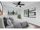 Beautifully staged bedroom showcasing new paint, comfortable bedding, sleek flooring, and abundant natural light at 9033 3Rd N St, St Petersburg, FL 33702