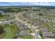 Aerial view of home in quiet neighborhood, featuring ponds and walking trails at 10815 Laxer Cay Loop, San Antonio, FL 33576
