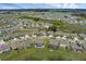 Aerial view of home nestled in a tranquil community with multiple ponds and lakes at 10815 Laxer Cay Loop, San Antonio, FL 33576