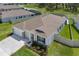 Stunning aerial view of the home, showcasing its great landscaping and proximity to the neighborhood lake at 10815 Laxer Cay Loop, San Antonio, FL 33576
