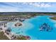 Aerial view of a lagoon filled with people and an aqua park featuring dining and white sandy beaches at 10815 Laxer Cay Loop, San Antonio, FL 33576