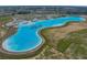 Picture shows an aerial view of the lagoon featuring sandy beach,遊 aqua park, swimming, and various water activities at 10815 Laxer Cay Loop, San Antonio, FL 33576