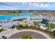 Aerial view of a lagoon surrounded by buildings, seating areas, and recreational zones at 10815 Laxer Cay Loop, San Antonio, FL 33576