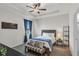 Cozy bedroom with carpet, ceiling fan, blue drapes, and neutral decor at 10815 Laxer Cay Loop, San Antonio, FL 33576
