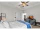 Neutral bedroom boasts a tray ceiling with fan, and access to the Primary bath at 10815 Laxer Cay Loop, San Antonio, FL 33576
