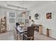 This open dining room features a modern light fixture, and a view of the homes exterior at 10815 Laxer Cay Loop, San Antonio, FL 33576