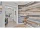 Spacious foyer featuring an accent wall, tile floors, and decorative lighting creating an inviting atmosphere at 10815 Laxer Cay Loop, San Antonio, FL 33576