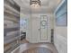 Beautiful foyer with eye-catching tile floor, accent wall, and decor perfect for welcoming guests at 10815 Laxer Cay Loop, San Antonio, FL 33576