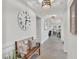 Bright hallway featuring a decorative bench, tile flooring, and modern lighting fixtures at 10815 Laxer Cay Loop, San Antonio, FL 33576