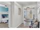 Inviting hallway with tile floors and stylish decor, leading to other areas of the home at 10815 Laxer Cay Loop, San Antonio, FL 33576