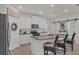 Well-equipped kitchen featuring granite countertops, stainless steel appliances, and a breakfast bar at 10815 Laxer Cay Loop, San Antonio, FL 33576