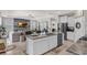 Modern kitchen boasts sleek countertops, stainless steel appliances, and flows into living room at 10815 Laxer Cay Loop, San Antonio, FL 33576