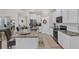 Modern kitchen boasts sleek countertops, stainless steel appliances, and flows into living area at 10815 Laxer Cay Loop, San Antonio, FL 33576