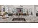 Bright, open kitchen with granite countertops and a view of the living area with a modern decorative wall at 10815 Laxer Cay Loop, San Antonio, FL 33576