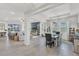 Open-concept living area with tile flooring, large windows, and modern furnishings for easy living at 10815 Laxer Cay Loop, San Antonio, FL 33576