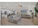 Bright and airy living room showcasing a large gray couch and tiled flooring at 10815 Laxer Cay Loop, San Antonio, FL 33576