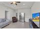 Large living room with stainless steel refrigerator, TV, and access to the laundry room at 10815 Laxer Cay Loop, San Antonio, FL 33576