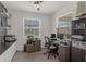 Functional home office with dual monitors, built-in shelves, and plenty of natural light at 10815 Laxer Cay Loop, San Antonio, FL 33576