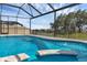 Beautiful screened pool and spa area with water features and lake view at 10815 Laxer Cay Loop, San Antonio, FL 33576