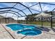 Beautiful screened pool area with serene view, sun umbrella, and brick patio flooring at 10815 Laxer Cay Loop, San Antonio, FL 33576