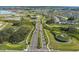 A picturesque road view showcasing nicely landscaped areas and serene ponds within the community at 10815 Laxer Cay Loop, San Antonio, FL 33576