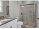 Bright bathroom with a granite countertop vanity and sleek glass-enclosed shower for a luxurious feel at 3137 Marine Grass Dr, Wimauma, FL 33598