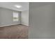 Bedroom featuring neutral paint, carpet flooring, and a window letting in natural light at 3137 Marine Grass Dr, Wimauma, FL 33598