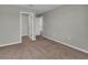 This bedroom features neutral walls, plush carpet, and a walk-in closet for storage at 3137 Marine Grass Dr, Wimauma, FL 33598
