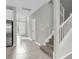 Bright hallway with staircase and views of kitchen at 3137 Marine Grass Dr, Wimauma, FL 33598