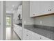 Elegant kitchen with stainless steel appliances, granite countertops, and ample cabinet space at 3137 Marine Grass Dr, Wimauma, FL 33598