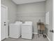 Clean laundry room equipped with a washing machine, dryer, sink, and storage at 3137 Marine Grass Dr, Wimauma, FL 33598