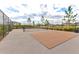 Outdoor pickleball court with chain-link fence and view of the community at 3137 Marine Grass Dr, Wimauma, FL 33598