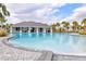 Community pool and clubhouse featuring a zero entry pool with seating and covered area at 3137 Marine Grass Dr, Wimauma, FL 33598