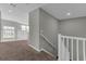 Staircase with carpeted steps, white railing and an overhead view of the foyer at 3137 Marine Grass Dr, Wimauma, FL 33598