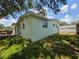 Home featuring a private backyard with a wooden deck and lush greenery at 1079 Woodbrook S Dr, Largo, FL 33770