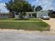 Charming single-story home with a well-maintained front yard and attached garage at 1079 Woodbrook S Dr, Largo, FL 33770