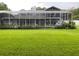 Expansive backyard with a screened patio, offering ample space for outdoor activities at 3009 Ridgevale Cir, Valrico, FL 33596