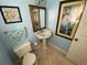 Charming powder room with a pedestal sink and decorative wall art at 3009 Ridgevale Cir, Valrico, FL 33596