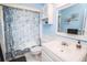 Bathroom featuring ocean-themed decor, blue wall paint, a vanity, a toilet and a shower at 3009 Ridgevale Cir, Valrico, FL 33596