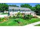 Beautifully landscaped home with mature trees and manicured lawn at 3009 Ridgevale Cir, Valrico, FL 33596