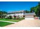 Charming two-story home featuring a well-manicured front yard and attached two car garage at 3009 Ridgevale Cir, Valrico, FL 33596