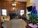 Cozy living room featuring a fireplace, wood paneled walls, and festive decorations at 3009 Ridgevale Cir, Valrico, FL 33596