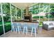 Covered outdoor kitchen featuring bar seating and a built-in grill at 3009 Ridgevale Cir, Valrico, FL 33596