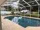 Sparkling screened-in pool and spa with well-manicured backyard offering a private and luxurious retreat at 3009 Ridgevale Cir, Valrico, FL 33596