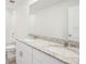 Bright bathroom featuring a granite-topped double vanity and a shower with a toilet to the left at 3550 Moscato Dr, Brooksville, FL 34602