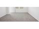 Spacious bedroom with plush carpeting, neutral walls, base molding, and natural light from windows at 3550 Moscato Dr, Brooksville, FL 34602
