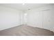 Bright bedroom with neutral carpet, white walls, and a sliding closet, offering versatility and style at 3550 Moscato Dr, Brooksville, FL 34602
